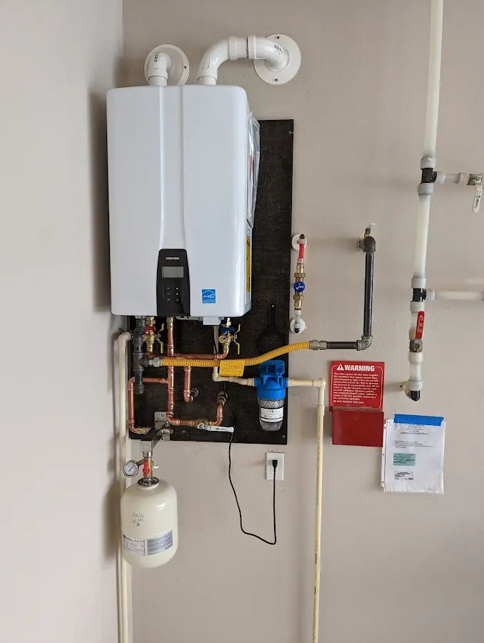 Professional plumber installing copper piping in a Hebron home